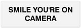 Signs ByLITA Basic Smile you're on camera Sign - Laser-Engraved Lettering | Durable ABS Plastic | Vibrant Colors | Powerful Foam Tape