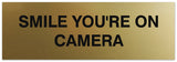 Signs ByLITA Basic Smile you're on camera Sign - Laser-Engraved Lettering | Durable ABS Plastic | Vibrant Colors | Powerful Foam Tape