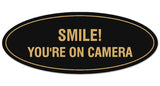 Signs ByLITA Oval Smile You're on Camera Sign - Laser-Engraved Lettering | Durable ABS Plastic | Vibrant Colors | Powerful Foam Tape