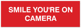 Signs ByLITA Basic Smile you're on camera Sign - Laser-Engraved Lettering | Durable ABS Plastic | Vibrant Colors | Powerful Foam Tape