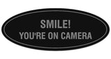 Signs ByLITA Oval Smile You're on Camera Sign - Laser-Engraved Lettering | Durable ABS Plastic | Vibrant Colors | Powerful Foam Tape
