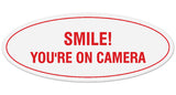 Signs ByLITA Oval Smile You're on Camera Sign - Laser-Engraved Lettering | Durable ABS Plastic | Vibrant Colors | Powerful Foam Tape
