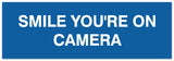 Signs ByLITA Basic Smile you're on camera Sign - Laser-Engraved Lettering | Durable ABS Plastic | Vibrant Colors | Powerful Foam Tape