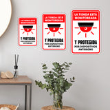 Portrait Round Plus La tienda está monitoreada y protegida por dispositivos antirrobo Wall or Door Sign | Spanish Dressing Room Retailer Signage