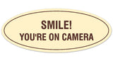 Signs ByLITA Oval Smile You're on Camera Sign - Laser-Engraved Lettering | Durable ABS Plastic | Vibrant Colors | Powerful Foam Tape