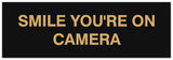 Signs ByLITA Basic Smile you're on camera Sign - Laser-Engraved Lettering | Durable ABS Plastic | Vibrant Colors | Powerful Foam Tape