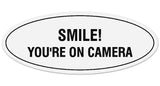 Signs ByLITA Oval Smile You're on Camera Sign - Laser-Engraved Lettering | Durable ABS Plastic | Vibrant Colors | Powerful Foam Tape